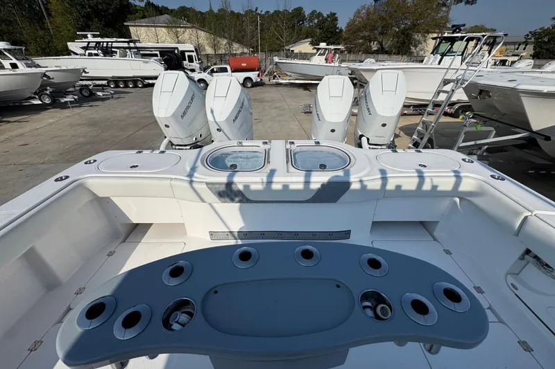 Slide: The Image of 2024 Invincible 46 Catamaran with Mercury engines, docked at a marina. - 37