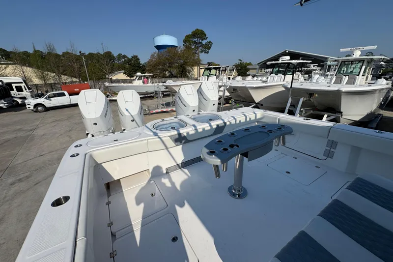 Slide: The Image of 2024 Invincible 46 Catamaran with quad engines, docked in a marina, showcasing spacious deck layout. - 38