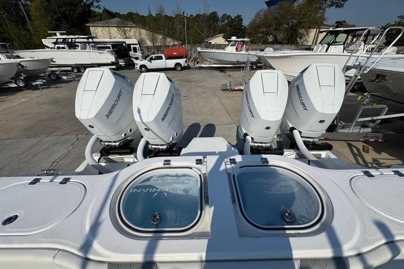Slide: The Image of 2024 Invincible 46 Catamaran with four Mercury outboard engines at a boatyard. - 39