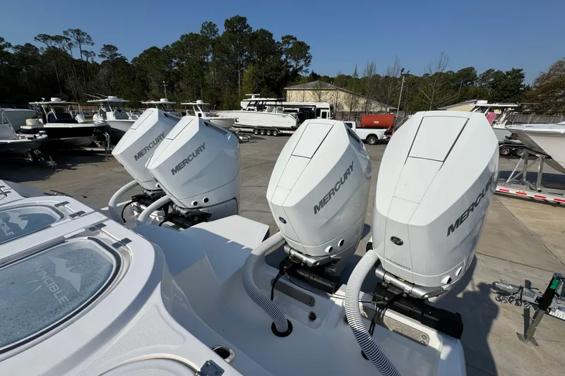 Slide: The Image of 2024 Invincible 46 Catamaran with Mercury outboard engines in a marina setting. - 40