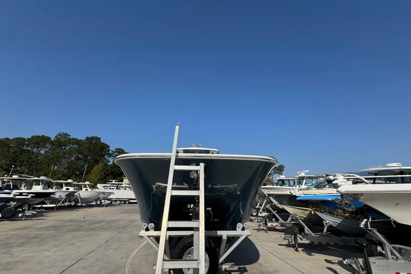 Slide: The Image of 2024 Invincible 46 Catamaran on trailer under clear blue sky. - 6