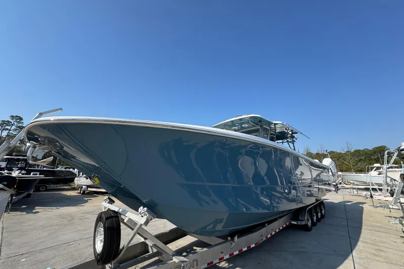 Slide: The Image of 2024 Invincible 46 Catamaran on trailer under clear blue sky. - 7