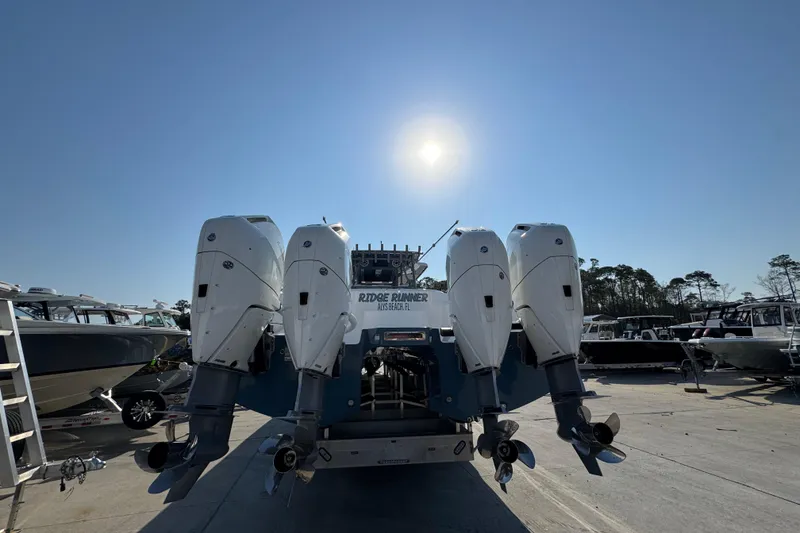 Slide: The Image of 2024 Invincible 46 Catamaran with four powerful outboard engines under a clear sky. - 8