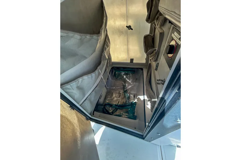 Slide: The Image of Interior storage compartment of a 1997 Boston Whaler 24 Outrage boat. - 10