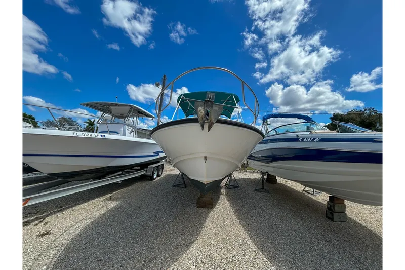 Slide: The Image of 1997 Boston Whaler 24 Outrage boat displayed outdoors under a blue sky. - 3