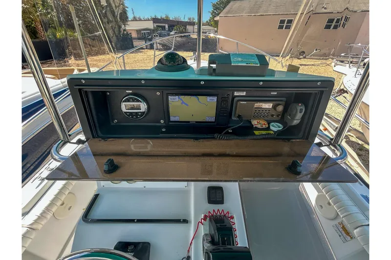 Slide: The Image of 1997 Boston Whaler 24 Outrage dashboard with navigation and communication equipment. - 5