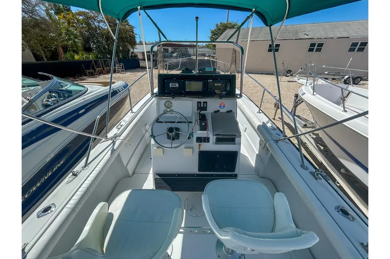 Slide: The Image of 1997 Boston Whaler 24 Outrage boat interior with steering console and seating. - 6