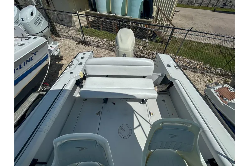 Slide: The Image of 1997 Boston Whaler 24 Outrage boat interior with seating and storage compartments. - 7