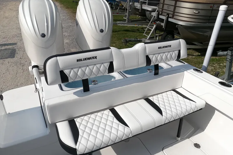 Slide: The Image of 2026 Bluewater Sportfishing 25T boat with dual engines and cushioned seating. - 13