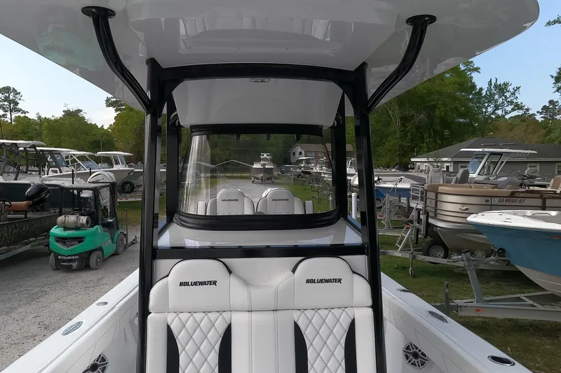 Slide: The Image of 2026 Bluewater Sportfishing 25T boat interior with white seating and black accents. - 18