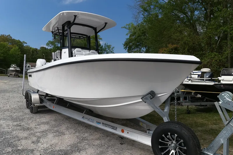 Slide: The Image of 2026 Bluewater Sportfishing 25T boat on trailer, parked outdoors, showcasing sleek design. - 3