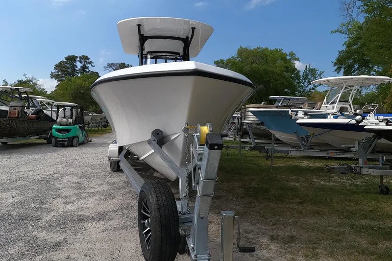 Slide: The Image of 2026 Bluewater Sportfishing 25T boat on trailer, surrounded by other boats, under clear sky. - 4