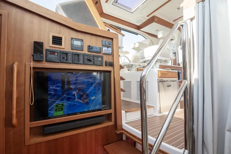 Slide: The Image of Interior of 2023 Back Cove 39O yacht with control panel and TV display. - 22
