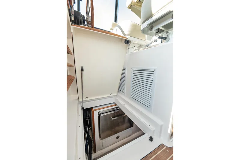 Slide: The Image of 2023 Back Cove 39O boat interior with storage compartment and wooden accents. - 29
