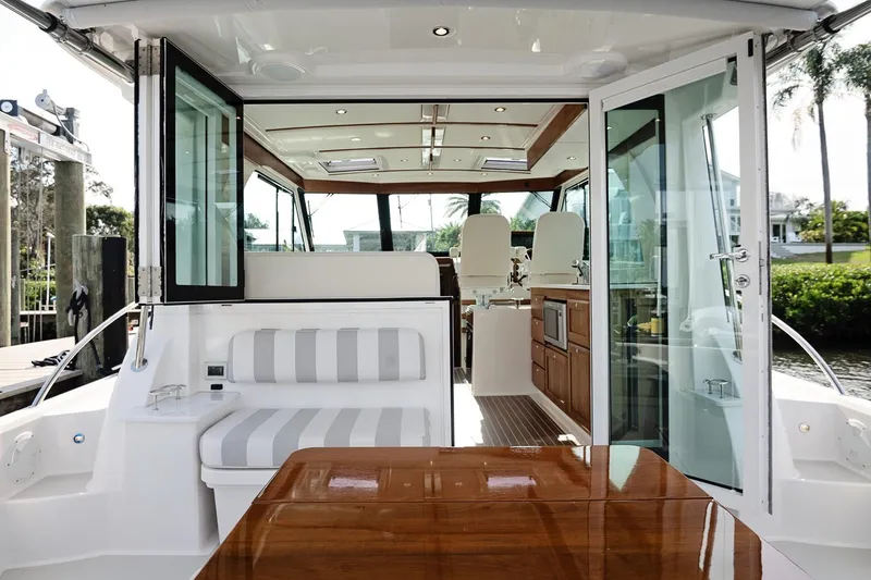 Slide: The Image of 2023 Back Cove 39O yacht interior with seating, table, and helm station. - 37