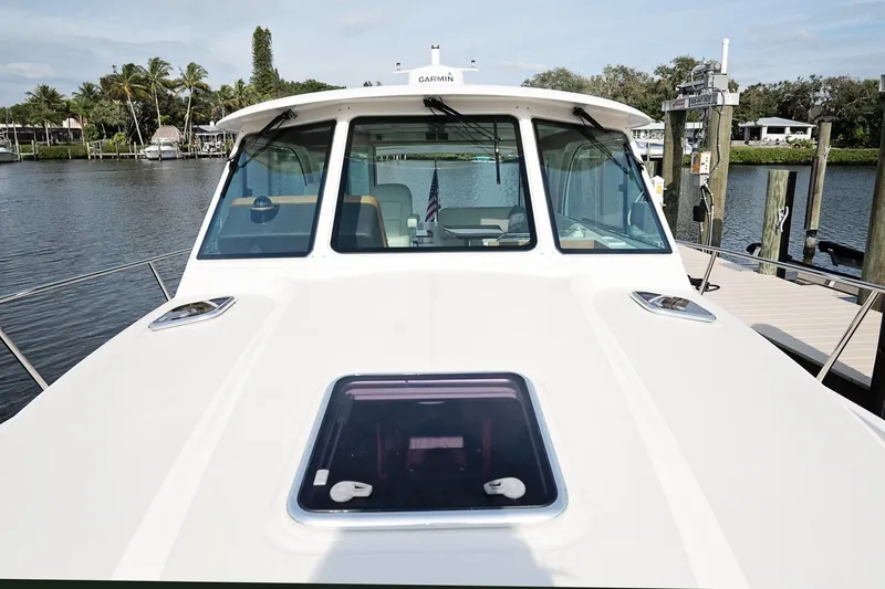 Slide: The Image of 2023 Back Cove 39O boat docked, showcasing sleek design and spacious deck. - 50