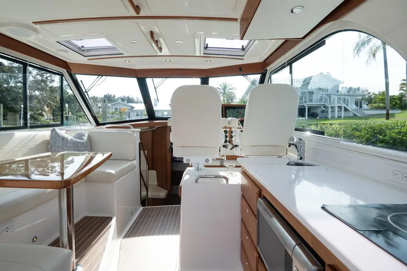 Slide: The Image of Luxurious interior of 2023 Back Cove 39O yacht with modern seating and kitchen area. - 6
