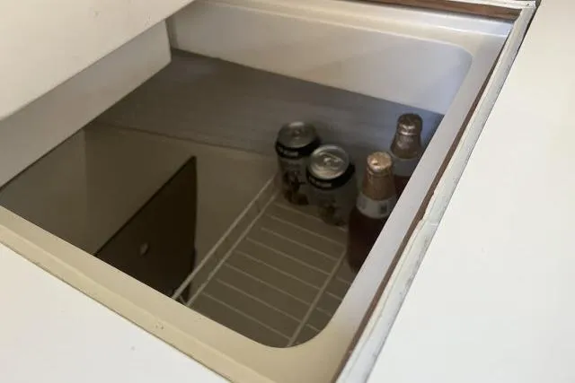 Slide: The Image of 1993 Catalina 36 MkII yacht kitchen with sink, stove, microwave, and wooden cabinetry. - 12