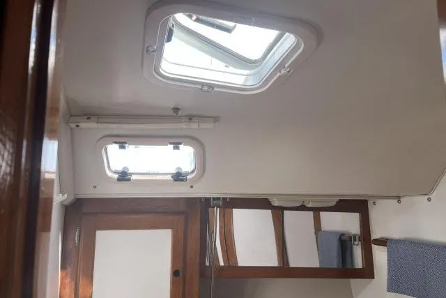 Slide: The Image of Interior cabin of 1993 Catalina 36 MkII sailboat with blue cushions. - 17