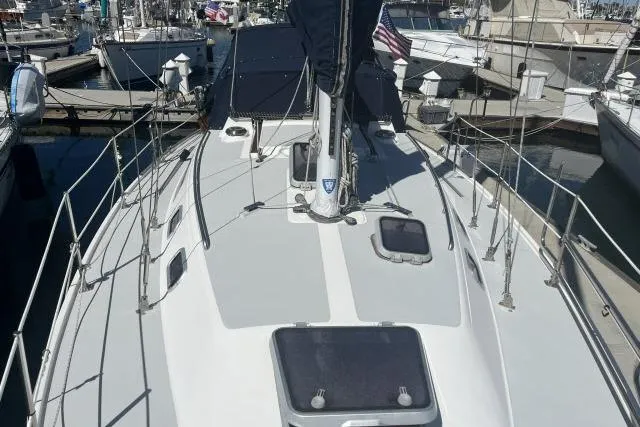 Slide: The Image of 1993 Catalina 36 MkII sailboat docked at marina, showcasing deck and rigging. - 32