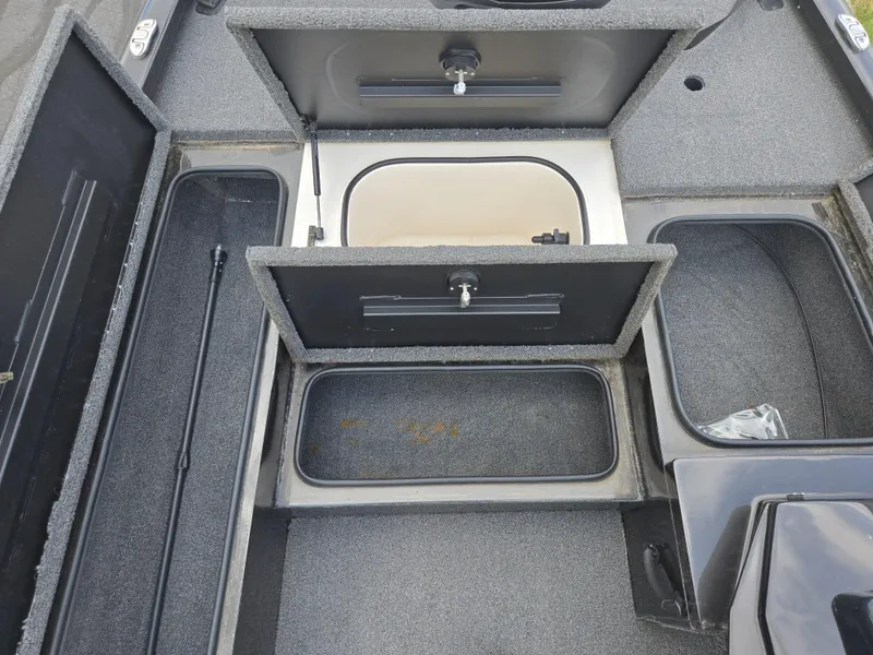 Slide: The Image of 2022 Vexus AVX181 boat storage compartments with open hatches, showcasing interior layout. - 16