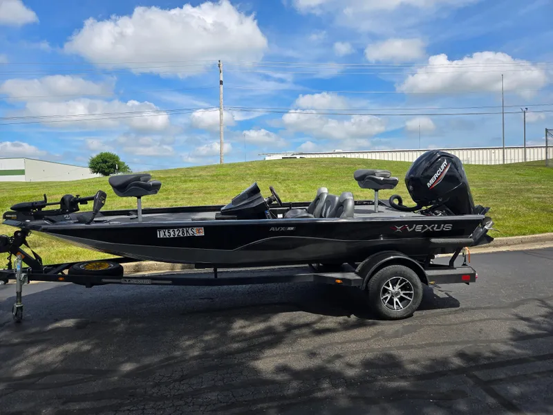 Slide: The Image of 2022 Vexus AVX181 boat on trailer, parked outdoors under a blue sky. - 4