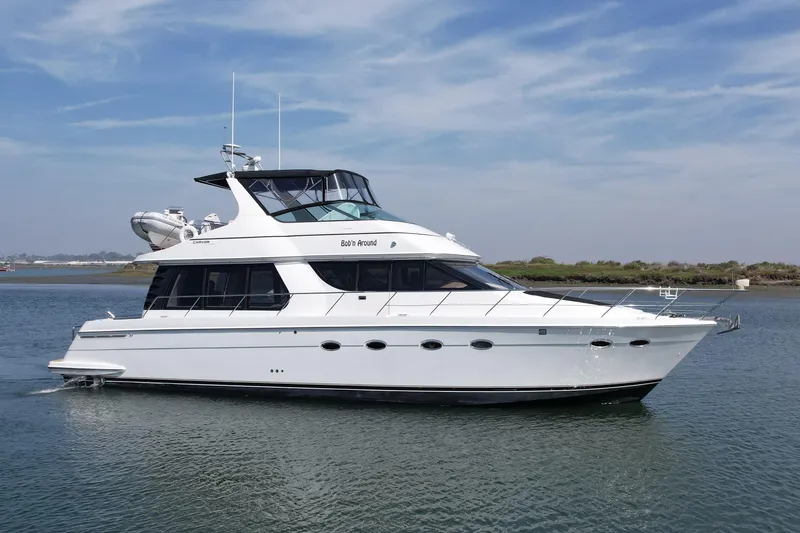The Image of 2000 Carver 53 Voyager yacht cruising on calm waters under a clear sky. - 0