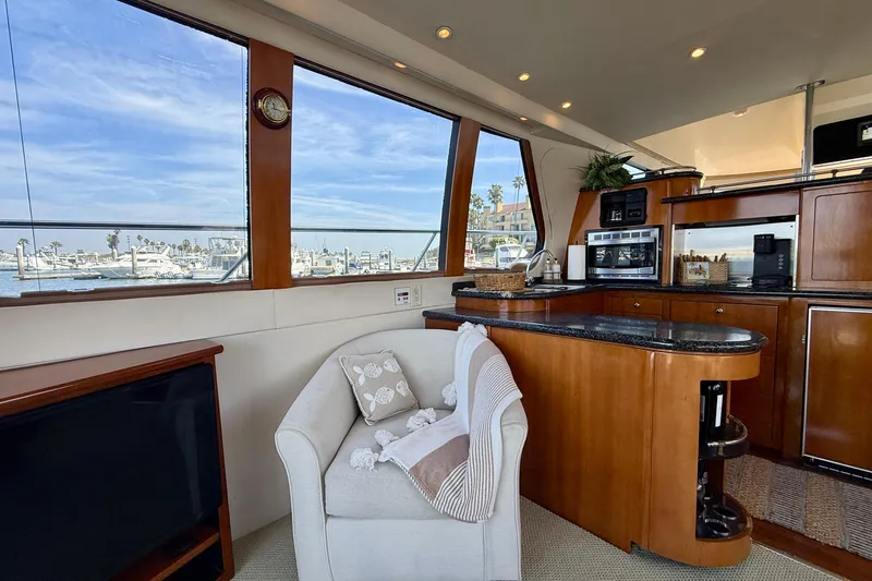Slide: The Image of Luxurious interior of 2000 Carver 53 Voyager yacht with elegant kitchen and cozy seating area. - 17