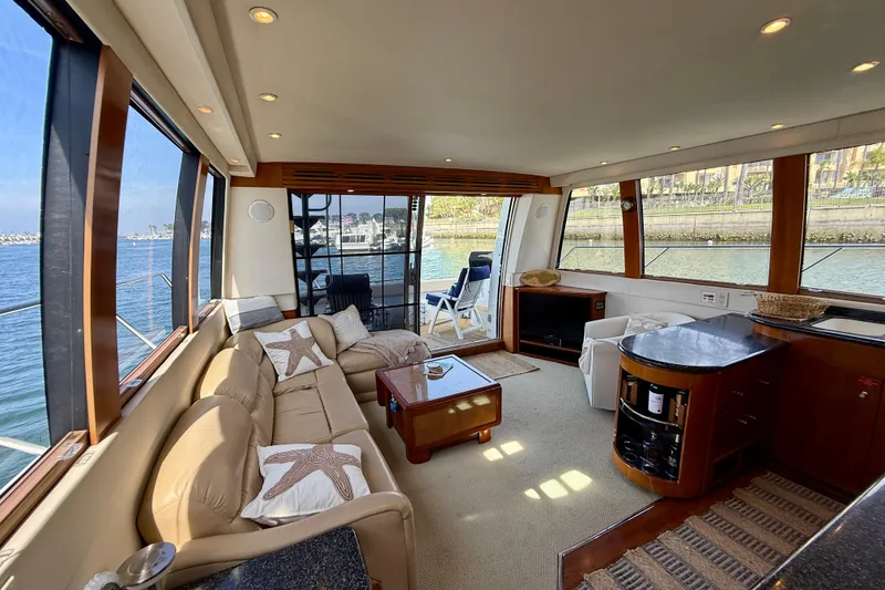 Slide: The Image of Luxurious interior of 2000 Carver 53 Voyager yacht with panoramic windows and elegant furnishings. - 19