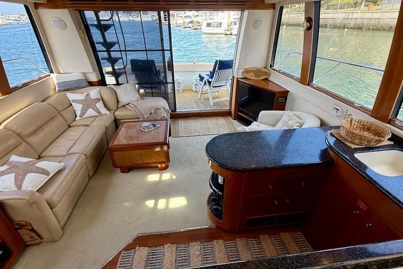 Slide: The Image of Luxurious interior of a 2000 Carver 53 Voyager yacht with elegant seating and waterfront view. - 22