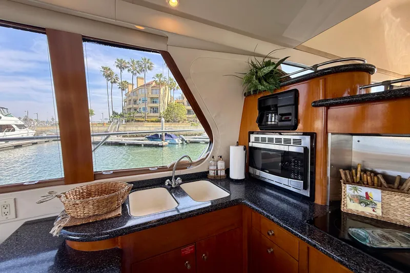 Slide: The Image of Interior of 2000 Carver 53 Voyager yacht kitchen with modern appliances and marina view. - 24