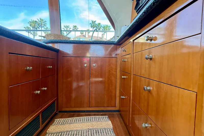 Slide: The Image of Interior of 2000 Carver 53 Voyager yacht with polished wooden cabinets and ocean view. - 26