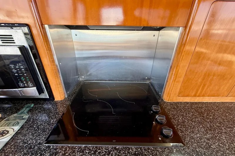 Slide: The Image of Modern kitchen area in a 2000 Carver 53 Voyager yacht with stovetop and microwave. - 27