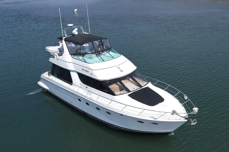 Slide: The Image of 2000 Carver 53 Voyager yacht cruising on calm waters. - 3