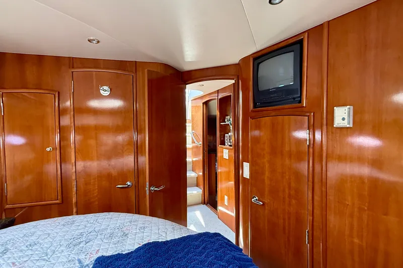 Slide: The Image of Interior of 2000 Carver 53 Voyager yacht with wood paneling and vintage TV. - 34