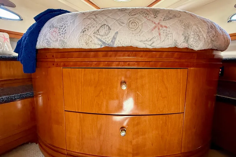 Slide: The Image of Interior of 2000 Carver 53 Voyager yacht with wooden cabinetry and bed. - 35