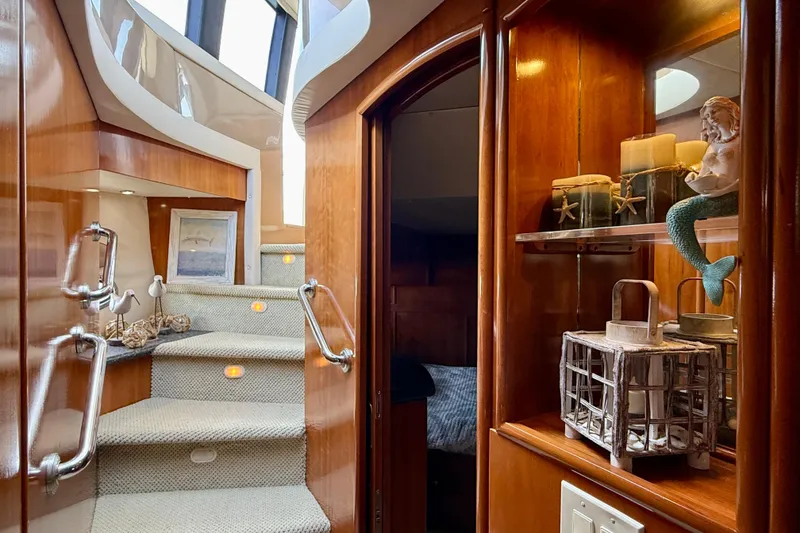Slide: The Image of Interior of 2000 Carver 53 Voyager yacht with elegant wooden staircase and nautical decor. - 40