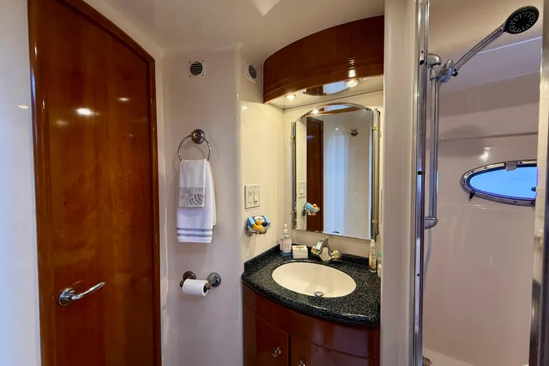 Slide: The Image of Luxurious bathroom in 2000 Carver 53 Voyager yacht with elegant fixtures and wood accents. - 42