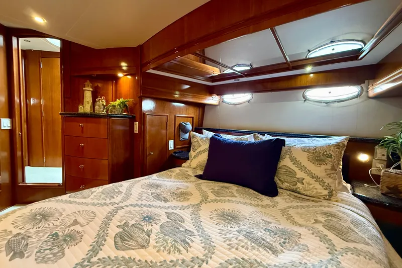 Slide: The Image of Luxurious bedroom interior of 2000 Carver 53 Voyager yacht with elegant wood finish. - 50