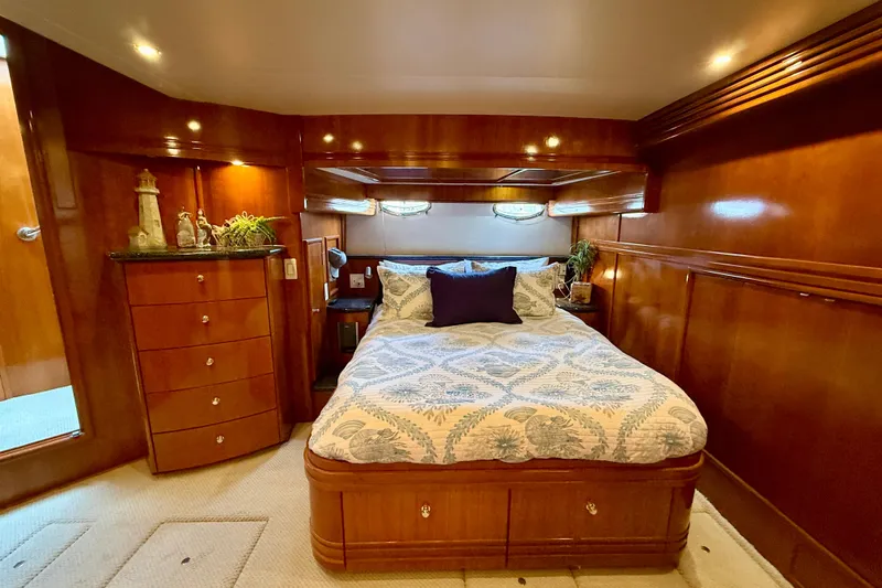 Slide: The Image of Luxurious bedroom interior of 2000 Carver 53 Voyager yacht with elegant wood finish. - 53