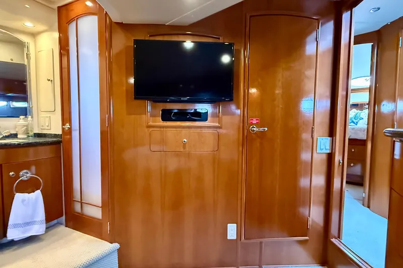 Slide: The Image of Interior of 2000 Carver 53 Voyager yacht with wood paneling and mounted TV. - 54