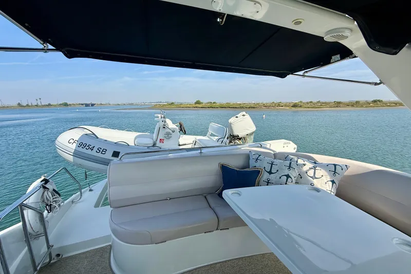 Slide: The Image of 2000 Carver 53 Voyager yacht interior with seating, table, and scenic water view. - 57