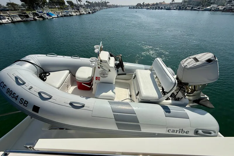 Slide: The Image of Inflatable boat on water near docked yachts, viewed from Carver 53 Voyager, 2000 model. - 58