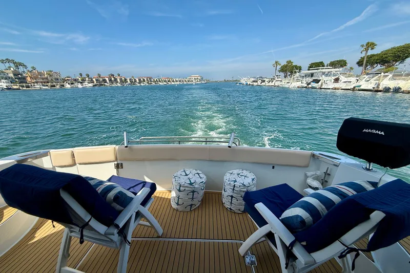 Slide: The Image of Aft deck view from 2000 Carver 53 Voyager yacht, featuring chairs and nautical decor. - 59