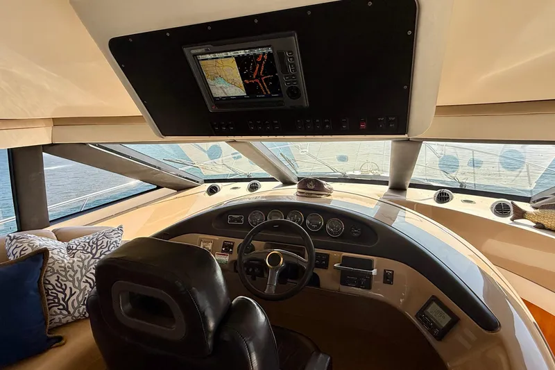 Slide: The Image of Interior helm of 2000 Carver 53 Voyager yacht with navigation equipment and plush seating. - 60