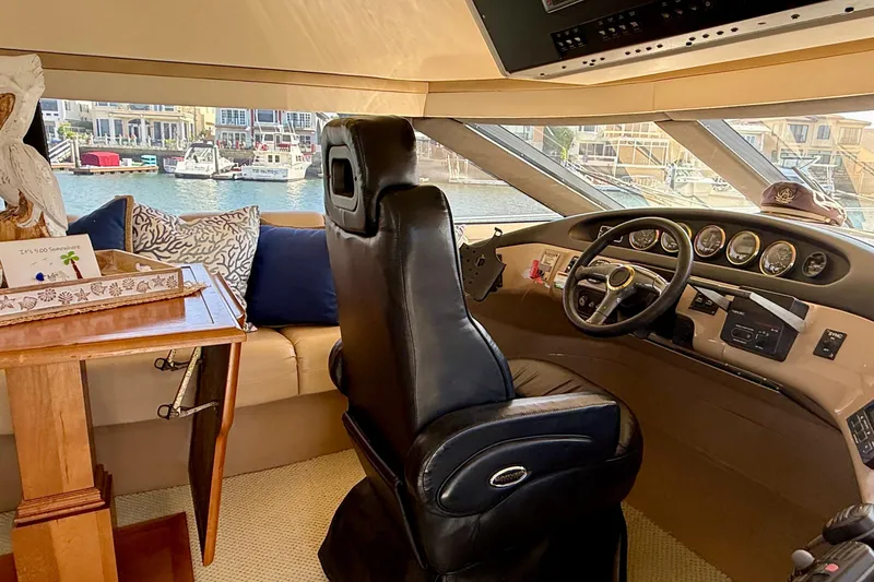 Slide: The Image of Interior of a 2000 Carver 53 Voyager yacht with helm and seating area. - 62