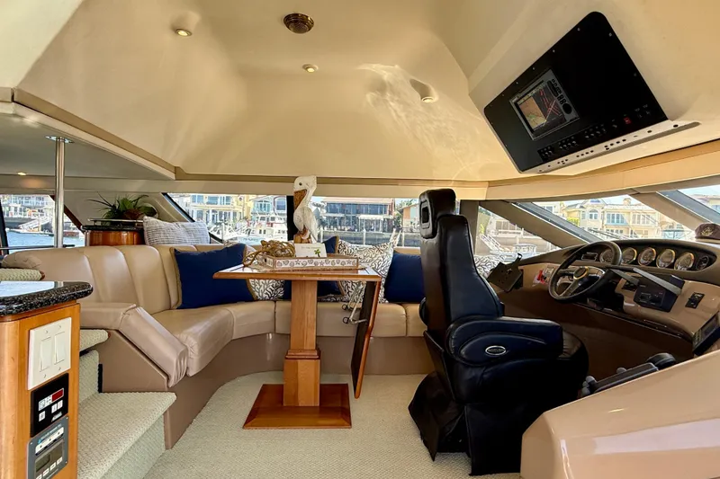 Slide: The Image of Luxurious interior of a 2000 Carver 53 Voyager yacht with plush seating and helm. - 63
