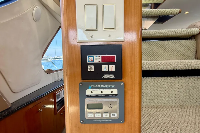 Slide: The Image of Control panel inside 2000 Carver 53 Voyager yacht, featuring watermaker and air conditioning systems. - 64