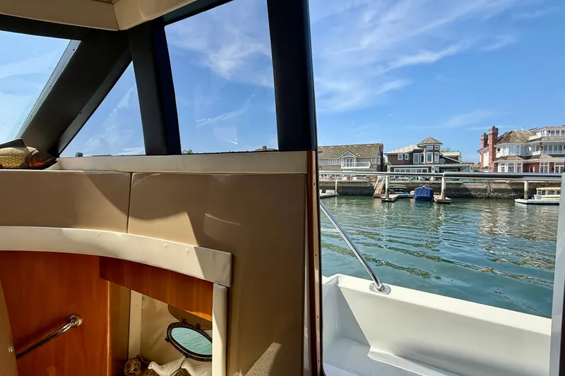 Slide: The Image of Interior view from a 2000 Carver 53 Voyager yacht, overlooking waterfront homes. - 66