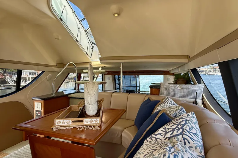 Slide: The Image of Interior of 2000 Carver 53 Voyager yacht with elegant seating and decorative pillows. - 69
